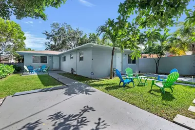 a house with chairs and a table in the yard at Modern 2BR Near Wynwood and Design District in Miami