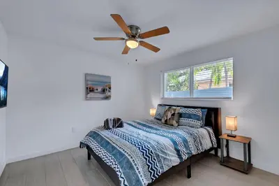 a bedroom with a bed with a ceiling fan at Stylish 2BR Retreat in Miamis Design District in Miami