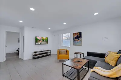 a living room with a couch and a table at Stylish 2BR Retreat in Miamis Design District in Miami