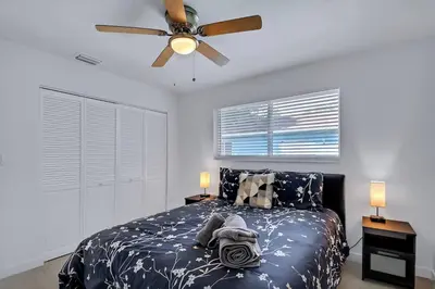 a bedroom with a bed and a ceiling fan at Stylish 2BR Retreat in Miamis Design District in Miami