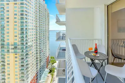 a balcony with a table and chairs and a view of the ocean at Newly Renovated Brickell Stay with Views and Amenities in Miami