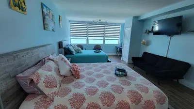 a bedroom with a large bed and a couch at Amazing ocean view studio 14 floor Free parking in Miami Beach
