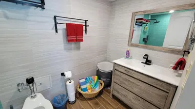 a bathroom with a sink and a toilet and a mirror at Amazing ocean view studio 14 floor Free parking in Miami Beach