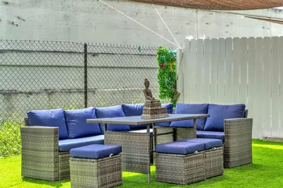 a table and chairs with a statue on top at Costerra Miami 2BR in Miami