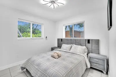 a bedroom with a bed with a stuffed animal on it at Costerra Miami 2BR in Miami
