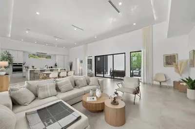 a living room with a white couch and a table at Villa Coral Wave in Miami