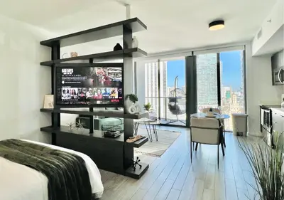 a bedroom with a bed and a desk with a television at SPECIAL OFFER - Luxury High Rise Downtown Miami - Bay Views and Top Amenities in Miami
