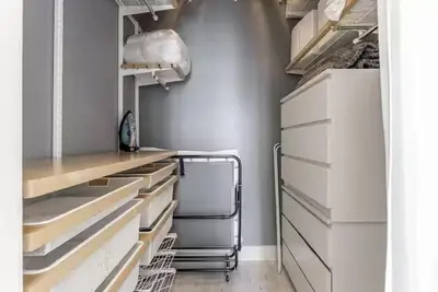 a kitchen with white drawers and a refrigerator at Beautiful Icon Brickell Double height ceiling in Miami