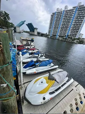 a row of boats are lined up on the water at Luxury Waterfront Condo Hilton Hotel Amenities Beach Pool Jacuzzi Jetskis Gym in Fort Lauderdale