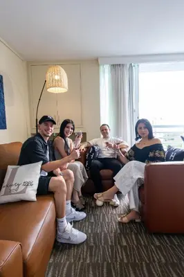 a group of people sitting on a couch in a room at Luxury Waterfront Condo Hilton Hotel Amenities Beach Pool Jacuzzi Jetskis Gym in Fort Lauderdale