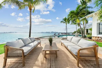 a patio with two white couches and a table at Villa Tropique in Miami Beach