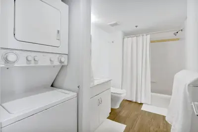 a white bathroom with a sink and a toilet at Brickell Bay Condo with Views plus Parking Sleeps 6 in Miami