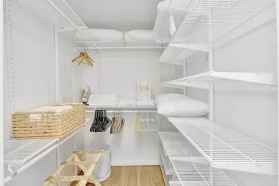 a white walk in closet with white shelves at Brickell Bay Condo with Views plus Parking Sleeps 6 in Miami