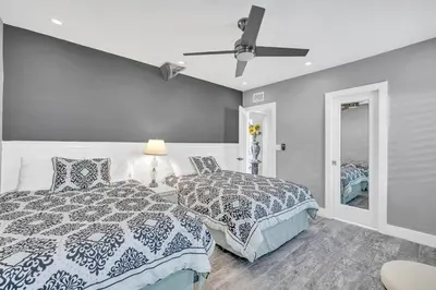 a bedroom with two beds and a ceiling fan at Miami Sombra - Prime Location-Parkfront- Den-Gazebo in Miami