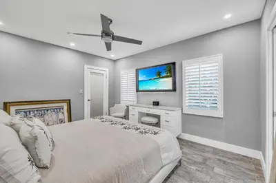a bedroom with a bed and a tv on the wall at Miami Sombra - Prime Location-Parkfront- Den-Gazebo in Miami