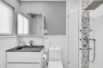 a bathroom with a sink and a toilet and a shower at Miami Sombra - Prime Location-Parkfront- Den-Gazebo in Miami