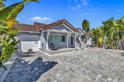 a home with a driveway in front of a house at Miami Sombra - Prime Location-Parkfront- Den-Gazebo in Miami