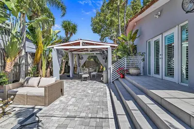 a patio with a white pergola and a couch at Miami Sombra - Prime Location-Parkfront- Den-Gazebo in Miami
