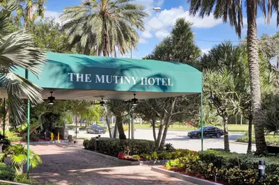 a sign for the mutiny hotel in a parking lot at Bayshore Charm-Free Parking in Miami