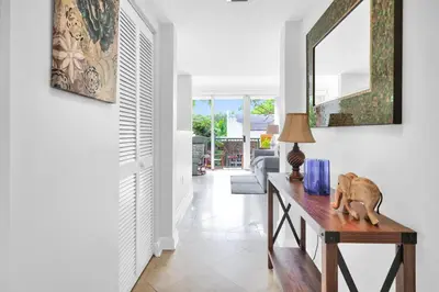 a room with a table with a lamp and a mirror at Sunny Getaway, Pool and Parking in Miami