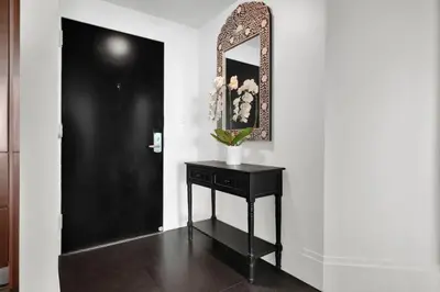 a room with a mirror and a table with a vase on it at Coastal Elegance and Luxury by the Water in Miami