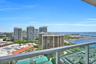 a balcony with a view of a city and the ocean at Grove Escape-Ocean Glimpse in Miami