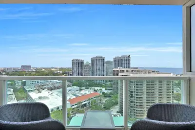 a balcony with chairs and a view of the city at Grove Escape-Ocean Glimpse in Miami
