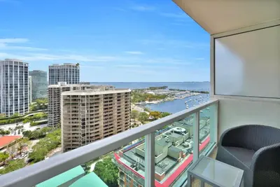 a balcony with a view of the ocean and buildings at Grove Escape-Ocean Glimpse in Miami