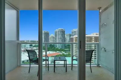 a balcony with a table and chairs and a view of the city at The Harmony - Ocean and Relaxation in Miami