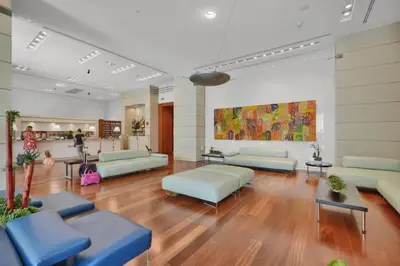 a waiting room with couches and tables in a building at The Harmony - Ocean and Relaxation in Miami