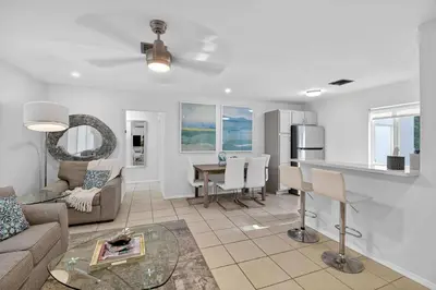 a living room with a couch and a table at Victoria Park's Secret Estate in Fort Lauderdale