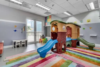 a childrens play room with a slide and a playground at Stunning 2B2B Ocean and City Views with Free Parking in Miami