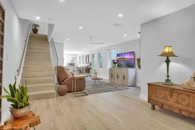 a living room with a staircase and a couch at Home Away From Home in Coconut Grove in Miami