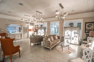 a living room with a couch and chairs and chandeliers at Henrosa Hotel in Miami Beach
