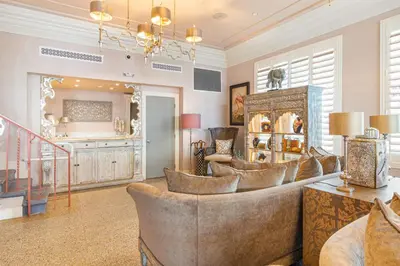 a living room with a bunch of chairs in it at Henrosa Hotel in Miami Beach