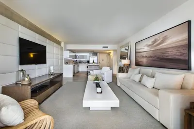a living room with a white couch and a tv at Lumina Residences 2BR Skyline Escape in Miami Beach