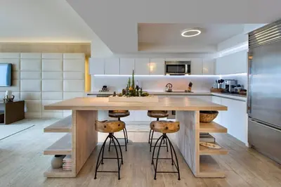 a kitchen with a large wooden table and stools at Lumina Residences 2BR Skyline Escape in Miami Beach