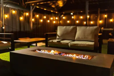 a living room with a couch and a fire pit at Parisian Vibe in Design District Miami with Private Pool BBQ Spacious Backyard in Miami