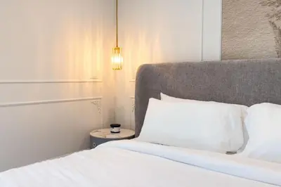 a bedroom with a white bed and a lamp at Parisian Vibe in Design District Miami with Private Pool BBQ Spacious Backyard in Miami