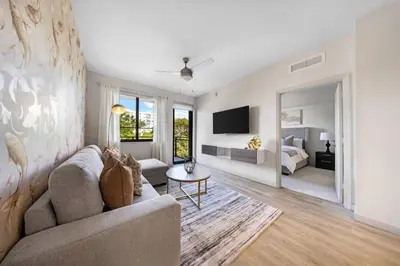 a living room with a couch and a bedroom at Aqua Luxe in DTWN 3 Min From Las Olas in Fort Lauderdale