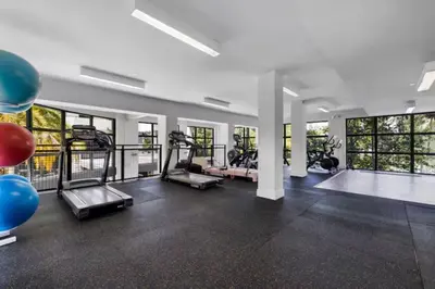 a gym with treadmills and elliptical machines at Aqua Luxe in DTWN 3 Min From Las Olas in Fort Lauderdale