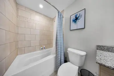 a bathroom with a tub and a toilet and a shower at Isla Blue in DTWN 3 Min From Las Olas in Fort Lauderdale