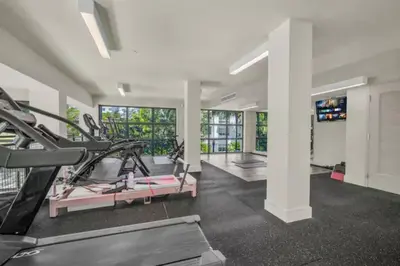 a gym with treadmills and elliptical machines at Isla Blue in DTWN 3 Min From Las Olas in Fort Lauderdale