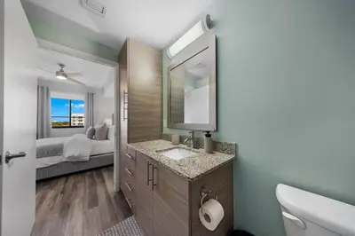 a bathroom with a sink and a mirror at Casa Palmera in DTWN 3 Min From Las Olas in Fort Lauderdale