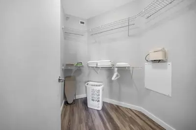 a bathroom with white walls and a trash can at Casa Palmera in DTWN 3 Min From Las Olas in Fort Lauderdale