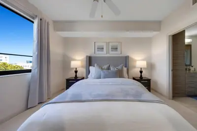a large bedroom with a large bed with two lamps at Prestige Living in DTWN 3 Min From Las Olas in Fort Lauderdale
