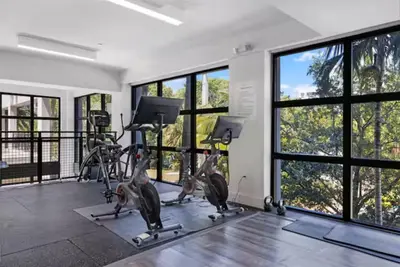 a gym with tread machines and large windows at Modern Palmera in DTWN 3 Min From Las Olas in Fort Lauderdale