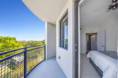 a bedroom with a bed and a balcony at Serene Bleu in DTWN 3 Min From Las Olas in Fort Lauderdale