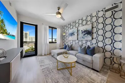 a living room with a couch and a table at Serene Bleu in DTWN 3 Min From Las Olas in Fort Lauderdale