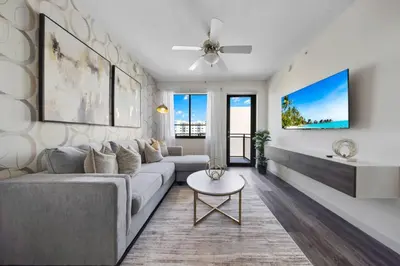 a living room with a couch and a table at The Serenity in DTWN 3 Min From Las Olas in Fort Lauderdale